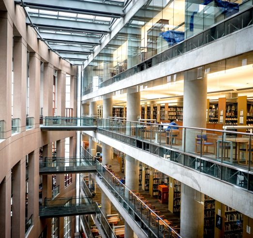 Foto i ett stort bibliotek med flera våningar synliga.